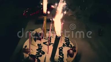 在生日蛋糕上燃烧火花，写着生日快乐。 生日快乐，火花像烟火一样燃烧，快乐